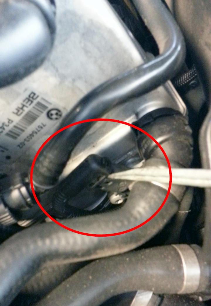 3) Locate the drivers side TMAP sensor shown above. We will be using a long flat screwdriver to gently pull the clip up from the side while tugging the plug out of the sensor.