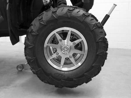 Place a chalk mark on the center line of the front tires approximately 10 (25.4 cm) from the floor or as close to the hub/axle center line as possible.