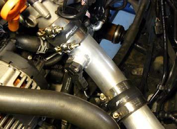 Attach the intercooler outlet pipe to the core using an enclosed 2.5 silicone coupler and two 2.875 T-bolt clamps.