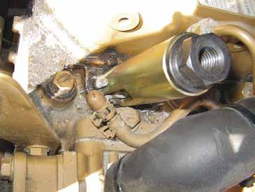 Thread 1/2" nut onto injector removal tool until injector is lifted out of injector socket.