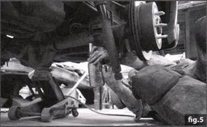 NOTE: In most cases it may be necessary to remove shock on bottom end (FIG 4) to allow axle to lower far enough for installation do