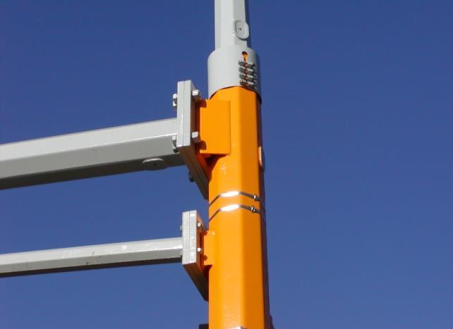The access openings are located on the back side of the vertical mast