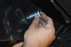 Remove the lower radius arm to axle bolts using a 24mm socket and a 27mm wrench.