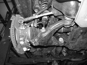 1) Loosen the bolts (2 per arm - 4 total). This will allow the lower control arm to swing down and out of the way when the strut is disconnected. Figure 1 Cut-off Tool or Grinder (step 8) 5.