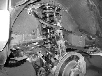 Figure 6 11. Swing the lower control arm up and fasten to the strut with the original factory hardware. Leave hardware loose. 12. Repeat the strut removal/assembly on the opposite side of the vehicle.