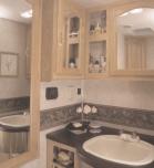 complete Model 351 BlackTie decor with beautiful cabinetry; an oak-framed, mirrored medicine cabinet; a solid-surface, decorcoordinated countertop; and a full-height fiberglass tub or shower