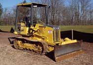 with teeth, enclosed ROPS cab with heat, and 22 DBG pads. In good condition with good undercarriage.