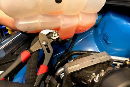 Pull the hose off the tank and catch any coolant that may spill out. Bucket Pour the remaining coolant into a container.