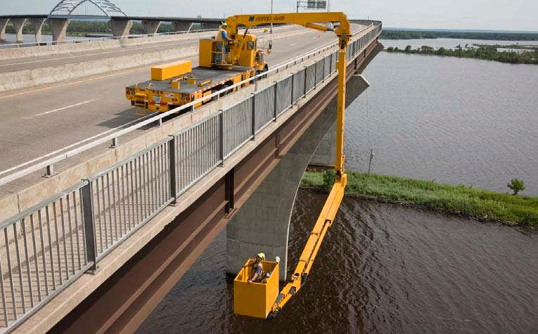 articulated boom designed to reach under the superstructure while parked on the bridge deck.