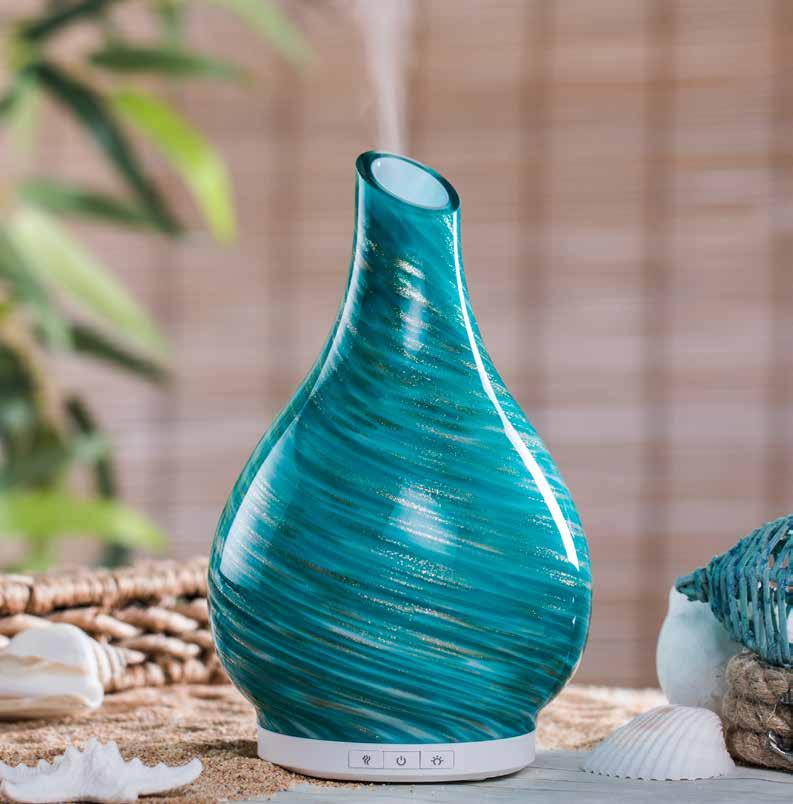 Seascape GLASS ULTRASONIC ESSENTIAL OIL DIFFUSER Suggested Retail $60.00 Each hand-blown glass cover features tranquil swirls of teal with gold highlights with an elegant silhouette.