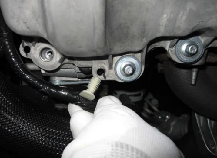 Using an 8 mm socket, an extension, and a universal joint