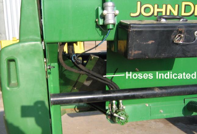 Hydraulic hoses for the LH belt drive motor can remain attached but must be pulled further from the frame approximately 50 mm (2 in) to accommodate the shift in the frame. See Figure 39.