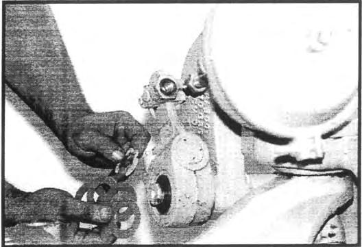 Install the large upper brake release spring. Then using a bar, pry the shoes away from the S-cam and insert the camshaft rollers. See Figure 26.
