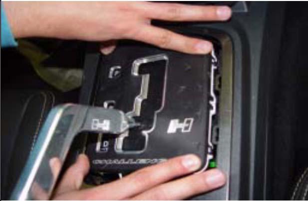 With the tabs in place from STEP 11, firmly push down on the passenger side of the Hurst plate to snap