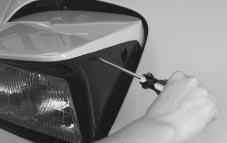 You can also open the headlamp doors manually by turning the adjuster counterclockwise. 2.