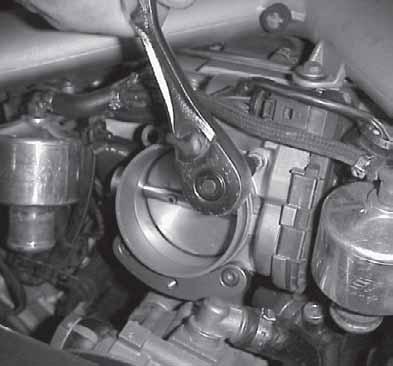29. Remove remaining throttle body bolt at