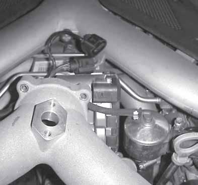 34. As the center section of the Bi-Pipe is aligned with the throttle body, be sure it clears the throttle body plug