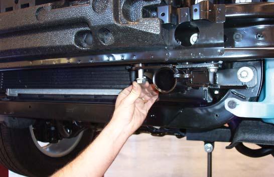 Place a ½" lock washer over a ½" x 2¼" bolt and bolt through the inside upper mounting point of the main receiver brace,