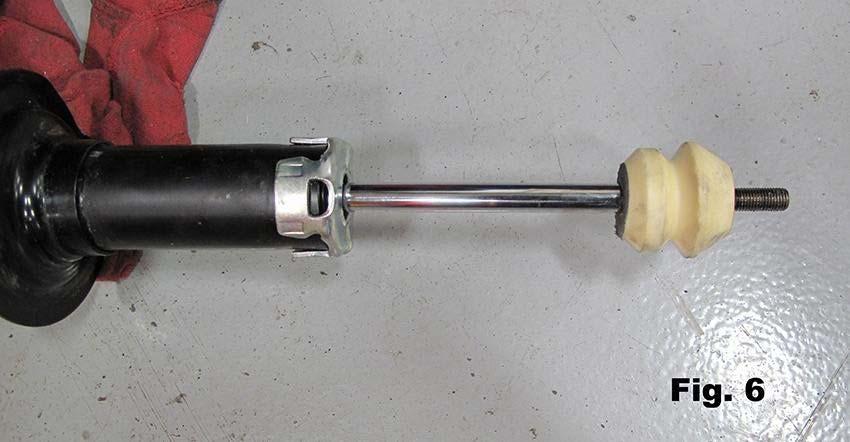 5) Remove center top nut and remove top mount, dust boot, and spring from shock. 6) Remove bump stop from shaft. 7) Install RCE bump stop onto shaft (Fig.