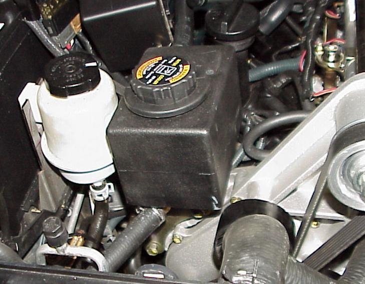 Tighten all nuts and bolts. 9. Trim and attach the pump hose installed in step 3 to the passenger side fitting on the heat exchanger. Secure with a hose clamp.(photo IC5) 10.