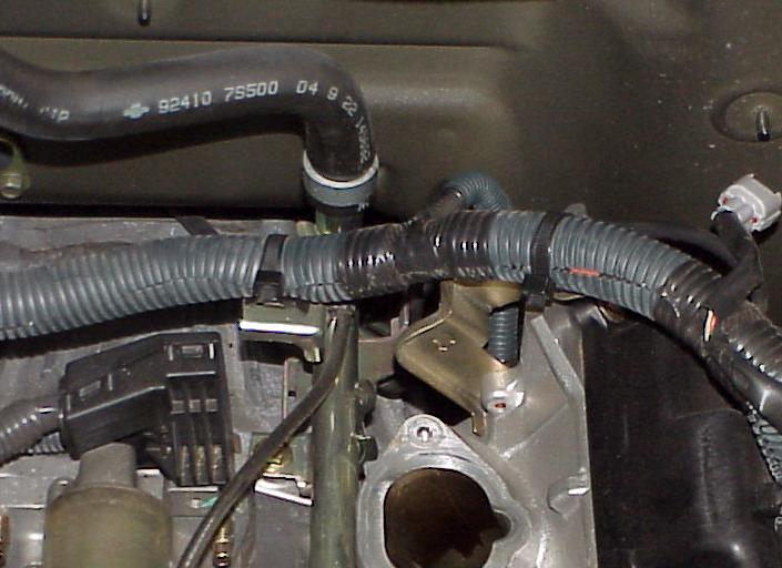 12. Unplug the fuel injectors and unclip the harness from the fuel rails. Disconnect the fuel line using the shortened 3/8 disconnect tool.