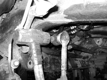 Set the tie rod assemblies aside, they will be modified later. Figure 17 30. Remove the steering center link from the pitman arm and idler arm assemblies.