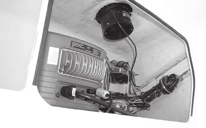 The head floor has a drain connected to a sump pump in the center bilge behind the access hatch in the rear head bulkhead. An opening port light above the sink provides daylight and ventilation.