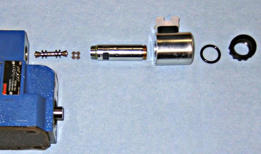 When the machine is turned off the center section can be depressed with a small wooden dowel. It will initially go in about a quarter inch [6 mm] and then the movement of the Valve Spool can be felt.