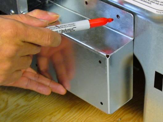 Use a metal punch to mark the center of the holes and drill