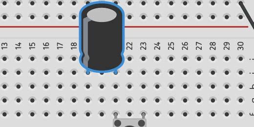 The capacitor is not connected into a circuit. Pressing the button will send current to the capacitor.