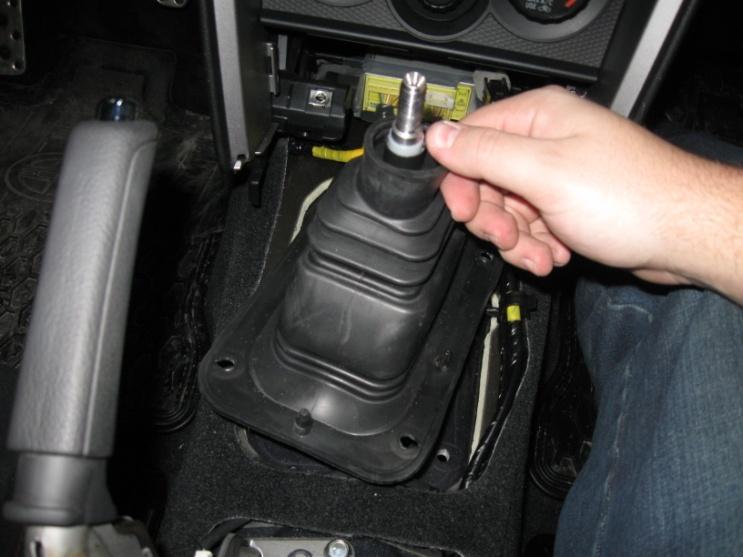 20. Remove the rubber boot by pulling upwards hard to slide it off the shifter.