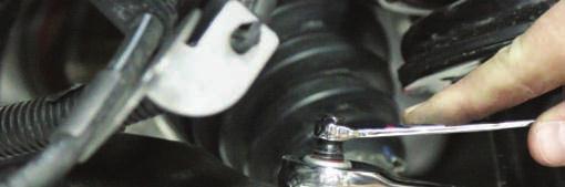 Use the appropriate tool to release ball joint from knuckle. See Photo 10.
