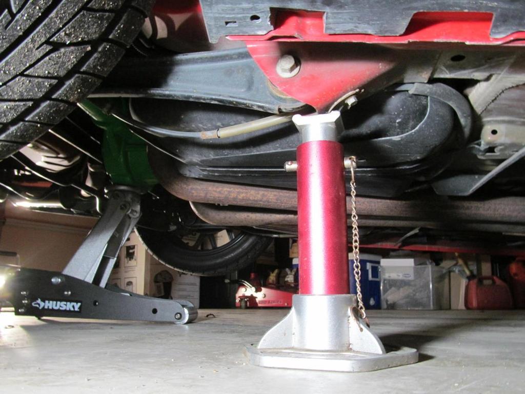 Place jack stands to suspend the rear of the car where each rear control arm