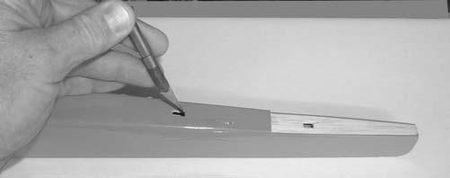 Collect the following items: (1) Fin (1) fuselage (1) Control Horn (2) Screws TAKING CARE NOT TO CUT INTO THE WOOD STRUCTURE UNDERNEATH, and working inside the drawn lines, carefully remove
