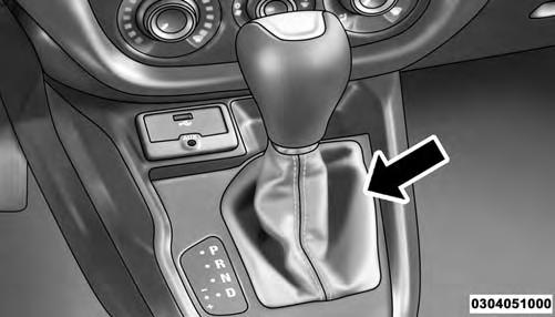 WHAT TO DO IN EMERGENCIES 323 6 Shift Lever Boot Location 4. Push and maintain firm pressure on the brake pedal. 5.