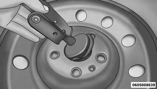 7. Pull the retainer through the center of the wheel. Retainer Preparations For Jacking 1. Park the vehicle on a firm level surface as far from the edge of the roadway as possible.