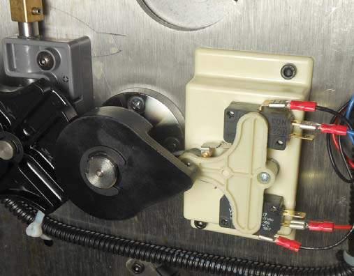 Neutral position for reversing movable C. The pinion cam is pointing to the right over the holding switch actuator. See Figure 27.