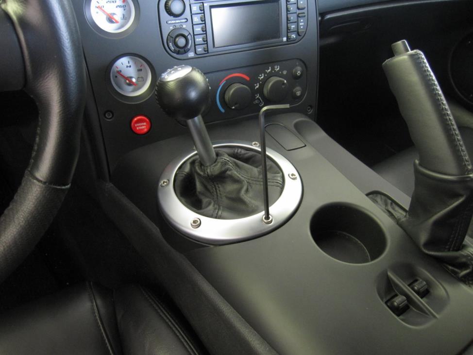 Installation Instructions: 1 Remove console shifter bezel Raise the parking brake handle to its most upright position Remove