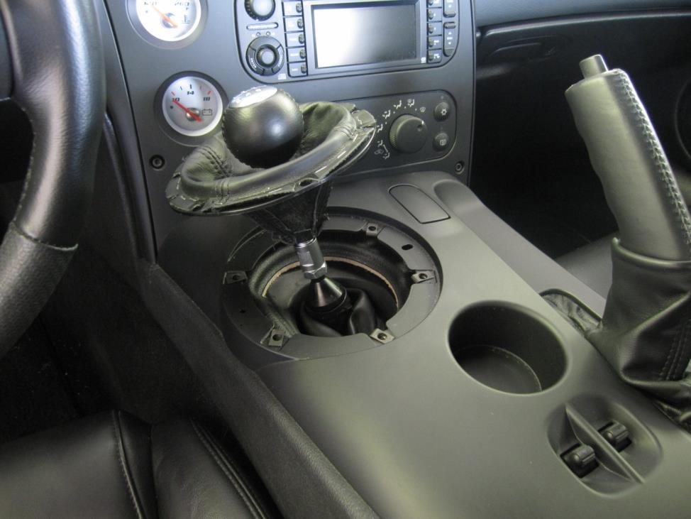 Invert the upper shift boot towards the shift knob to gain access to the retaining nut