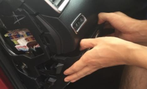 3. Carefully pull on the driver's lower dash panel to disengage the clips.