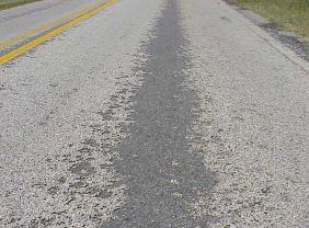 WEATHERING AND RAVELING Weathering and raveling are the wearing away of the pavement surface due to a loss of asphalt or dislodged aggregate particles.
