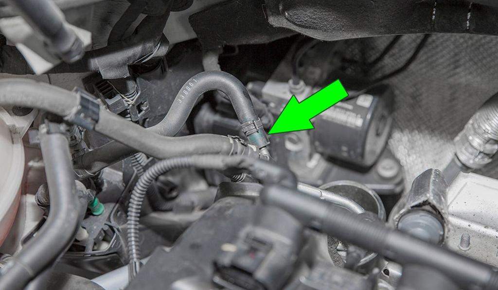 Disconnect the rear vacuum line from the