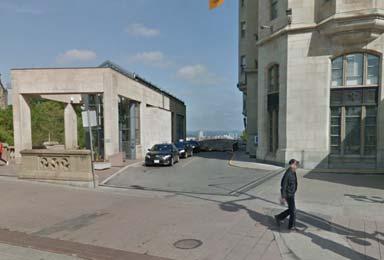 A secondary driveway at the southwestern corner of the site provides two-way access between the parking garage and Rideau Street.
