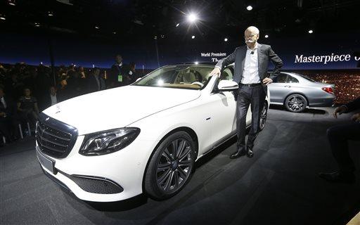 Dieter Zetsche, chairman of the board of management Daimler AG and Head of Mercedes-Benz Cars stands next to the automaker's new E-Class sedan during a preview night for the North American