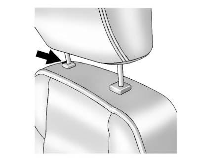 To raise or lower the head restraint, press the release button located on the side of the head restraint and pull up or push the head restraint down and release the button.