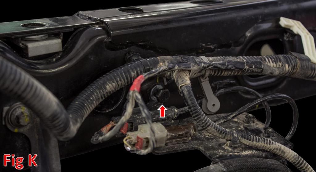 Using a 10mm Socket, remove the wiring bracket that is on the inner rail of the driver side frame above the axle. (Fig K) 12.