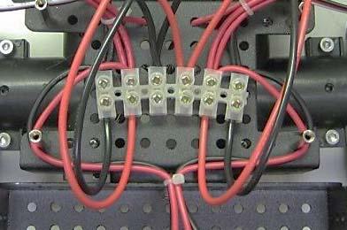You should not be crossing any wires over to another terminal block.