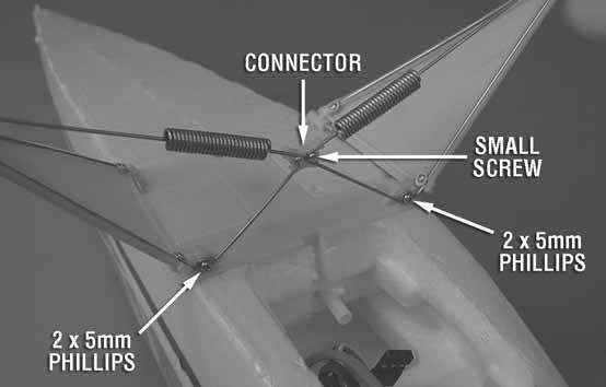 Remove the small screw from the plastic landing gear wire connector that is not already