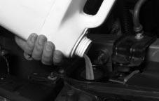 7. Replace the 3800 Series II V6 engine cover shield. A. Remove the oil fill tube, with cap attached, from the valve cover. B. Insert the catch tab on the cover shield under the bracket on the engine.