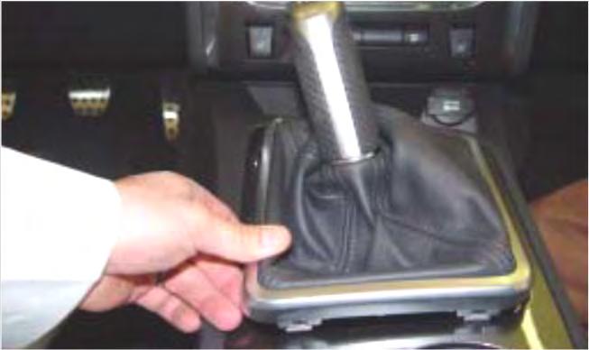 remove knob, boot, stick assembly. TOOL: 1/2 Wrench 3.